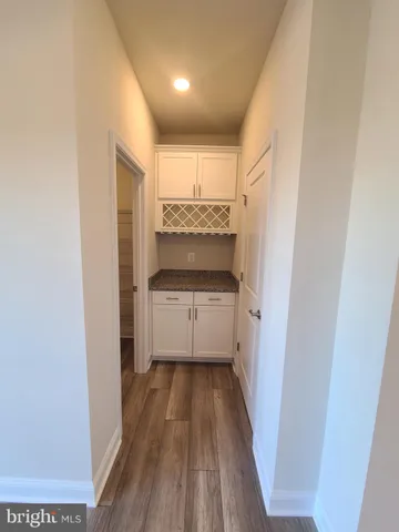 a view of hallway with wooden floor