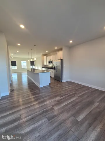 a view of kitchen view wooden floor and living room view