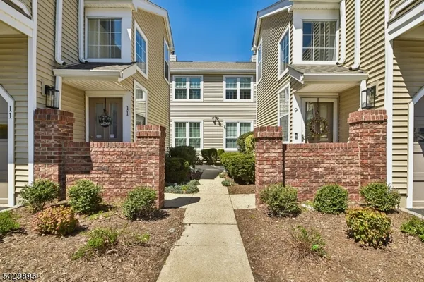 front view of a brick house with a small yard