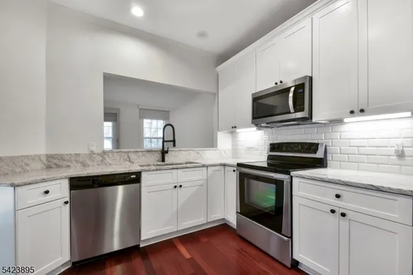 a kitchen with a sink stove and microwave
