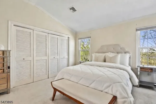a spacious bedroom with a bed and a window