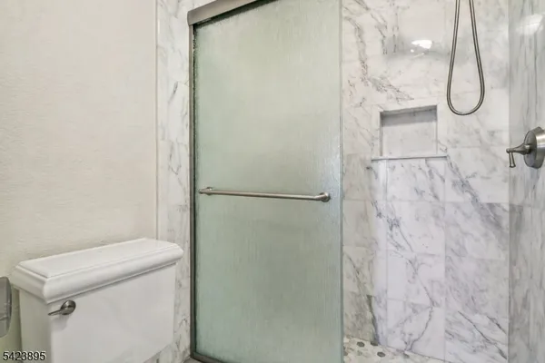 a bathroom with a granite countertop shower and a sink