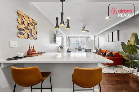 a view of a dining room with furniture and a chandelier