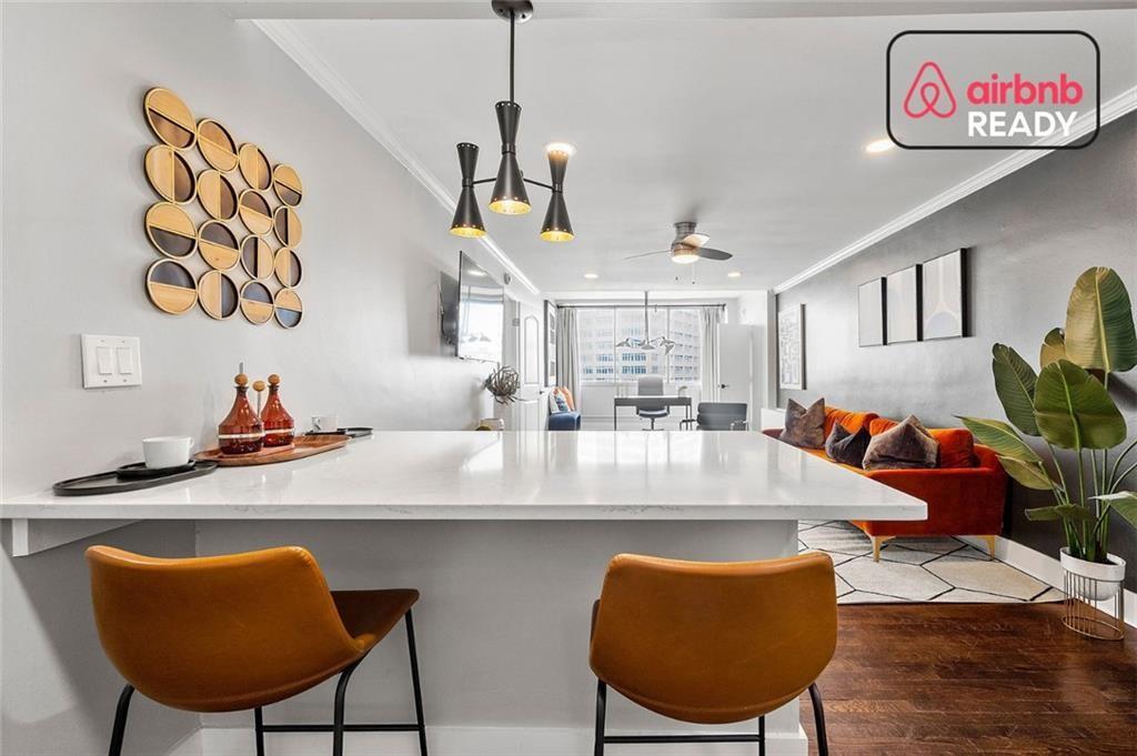 a view of a dining room with furniture and a chandelier