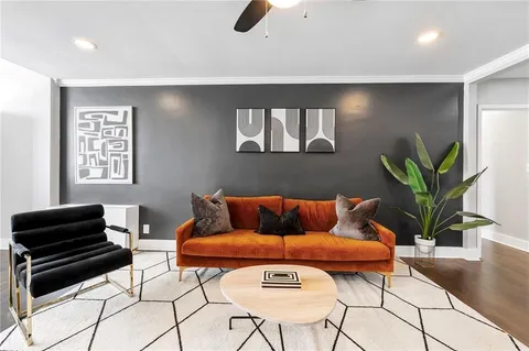 a living room with furniture and a potted plant