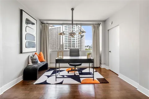 a living room with furniture and floor to ceiling window