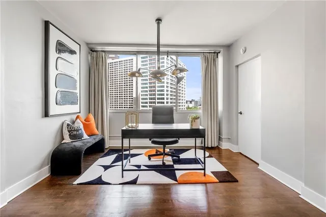 a living room with furniture and floor to ceiling window
