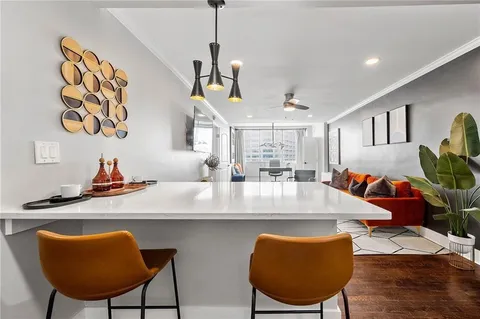 a view of a dining room with furniture and a chandelier