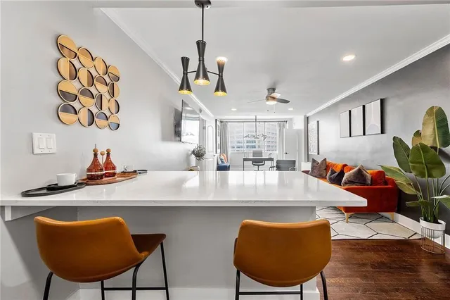 a view of a dining room with furniture and a chandelier