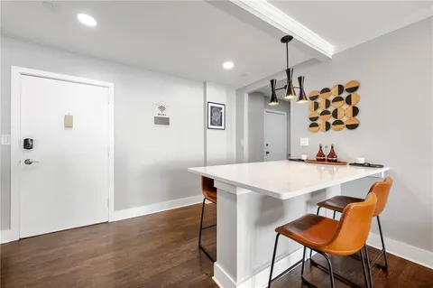 a view of a dining room with furniture and wooden floor