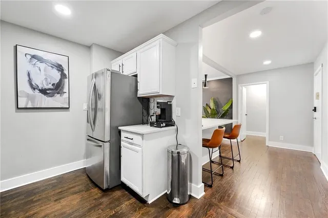 a view of a workspace with furniture and wooden floor