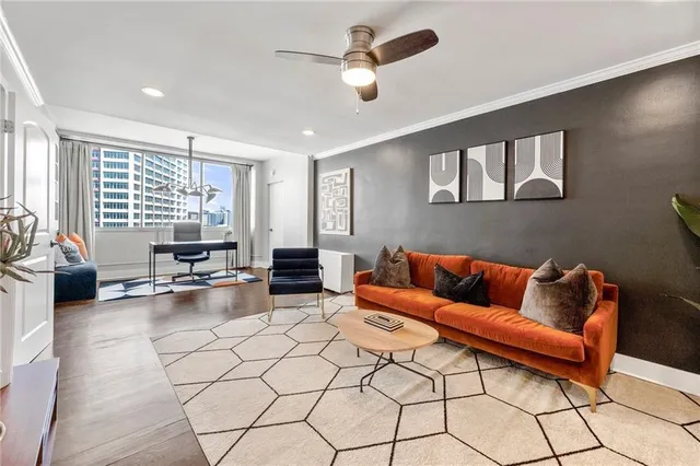 a living room with furniture and floor to ceiling window