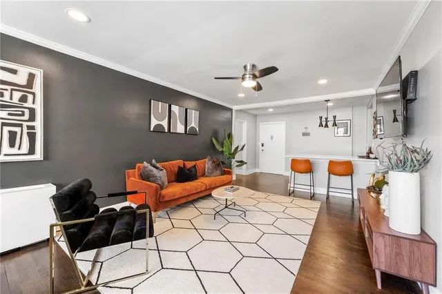 a living room with furniture and wooden floor