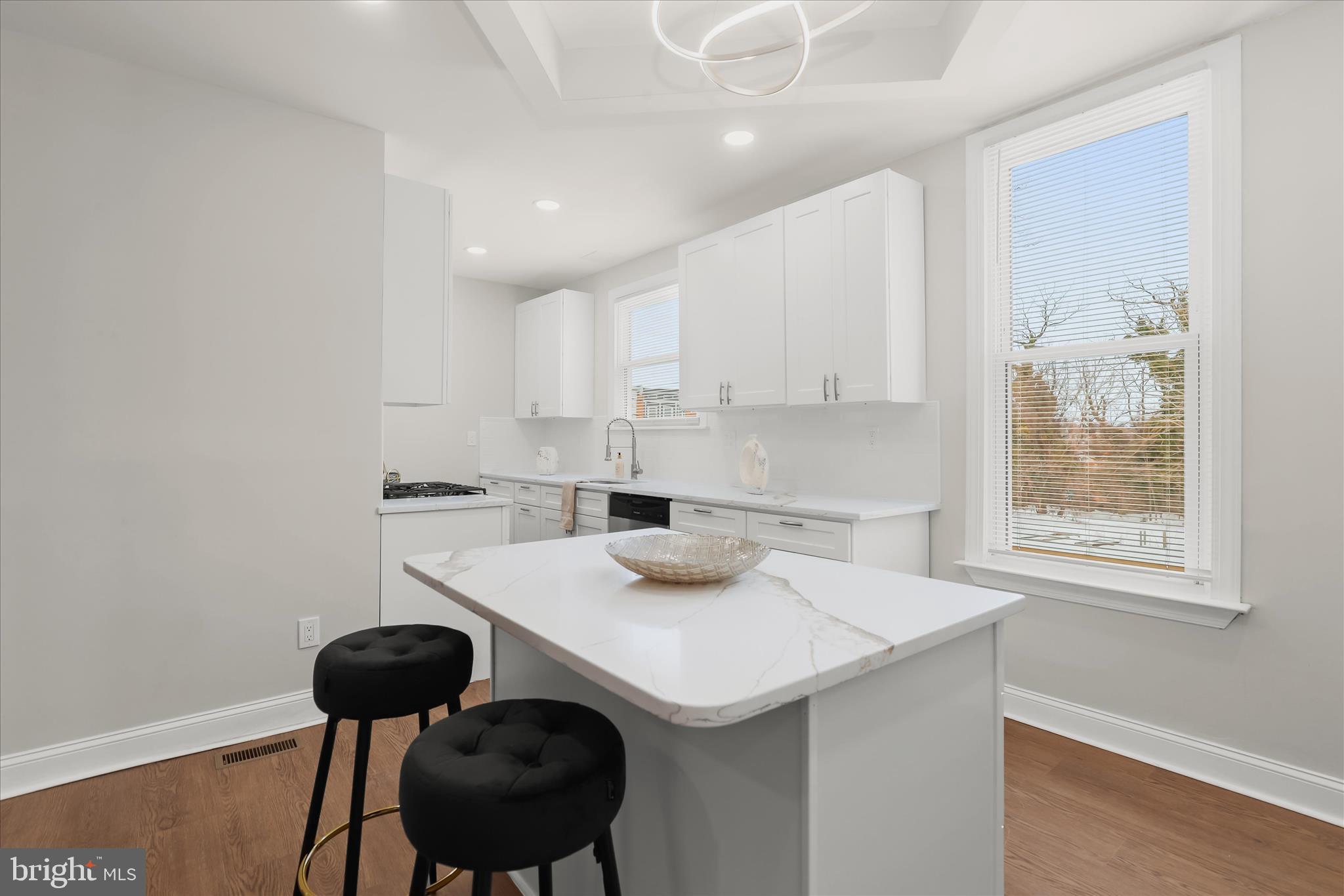 701 East 43rd Street Baltimore, MD 21212 - Photo 14 of 47 a kitchen with a sink a stove and chairs