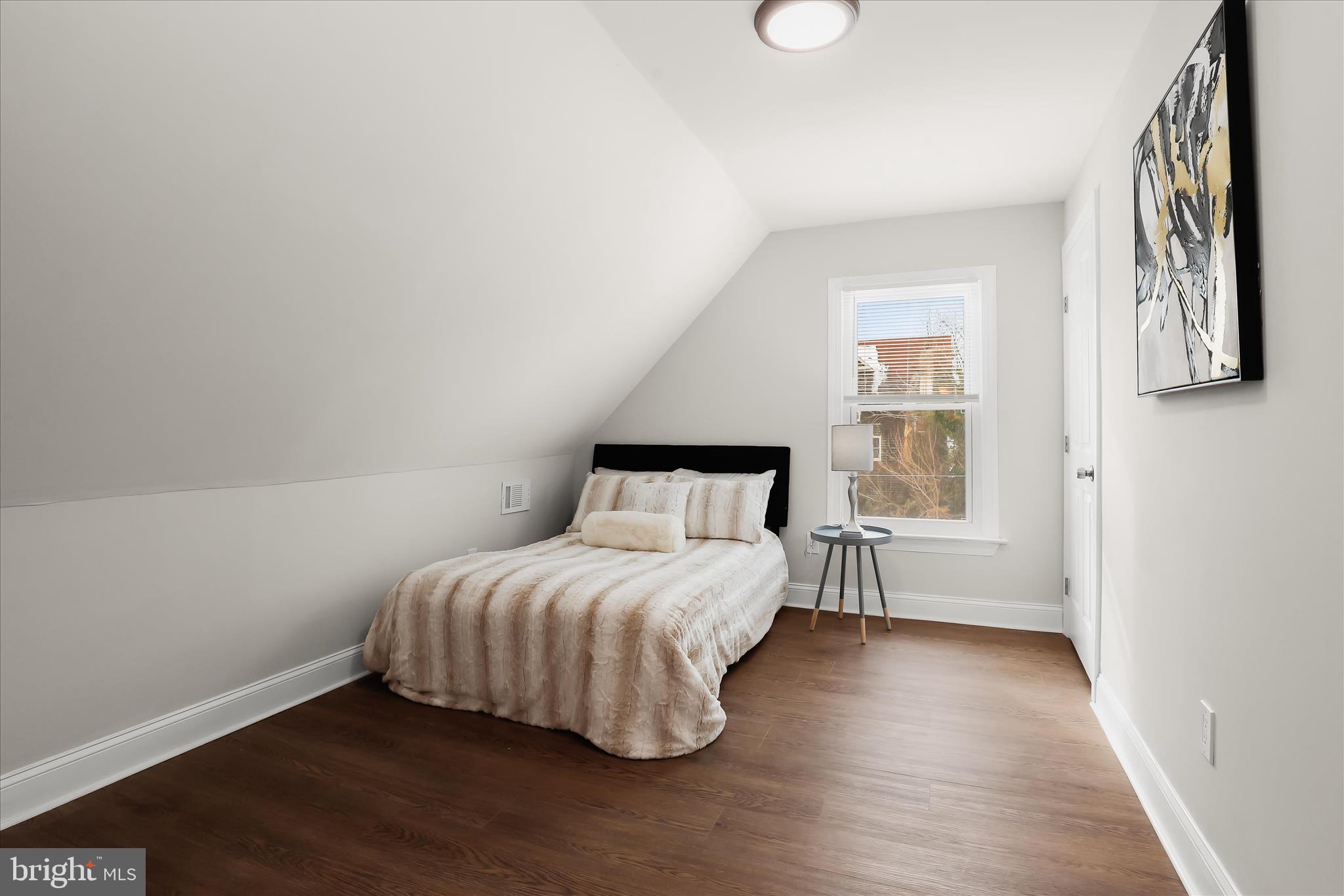 701 East 43rd Street Baltimore, MD 21212 - Photo 34 of 47 a bedroom with a bed and wooden floor