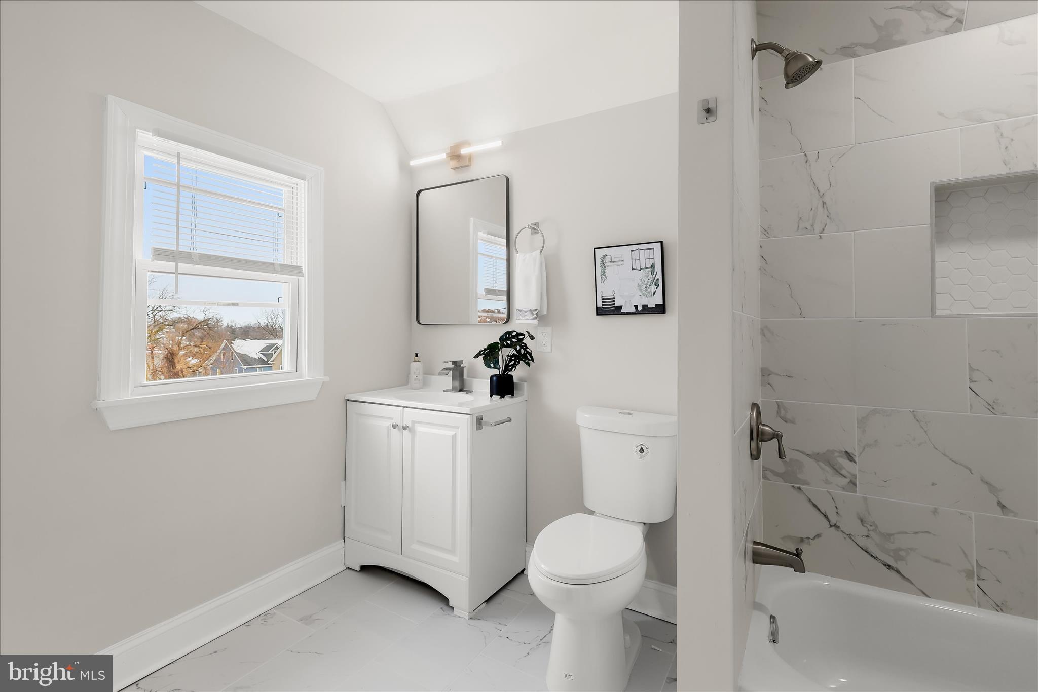 701 East 43rd Street Baltimore, MD 21212 - Photo 40 of 47 a white toilet sitting next to a bathroom sink and tub