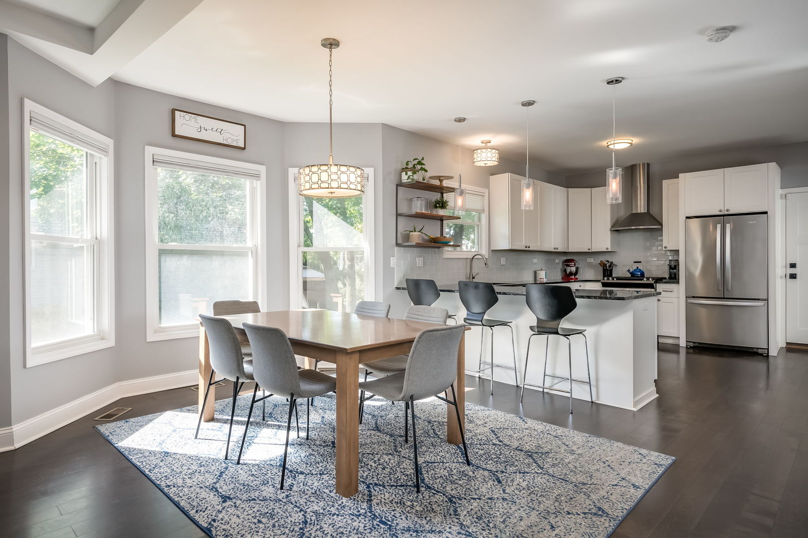 803 South Maple Avenue Oak Park, IL 60304 - Photo 8 of 31 a kitchen with stainless steel appliances granite countertop a stove a refrigerator a kitchen island a table and chairs