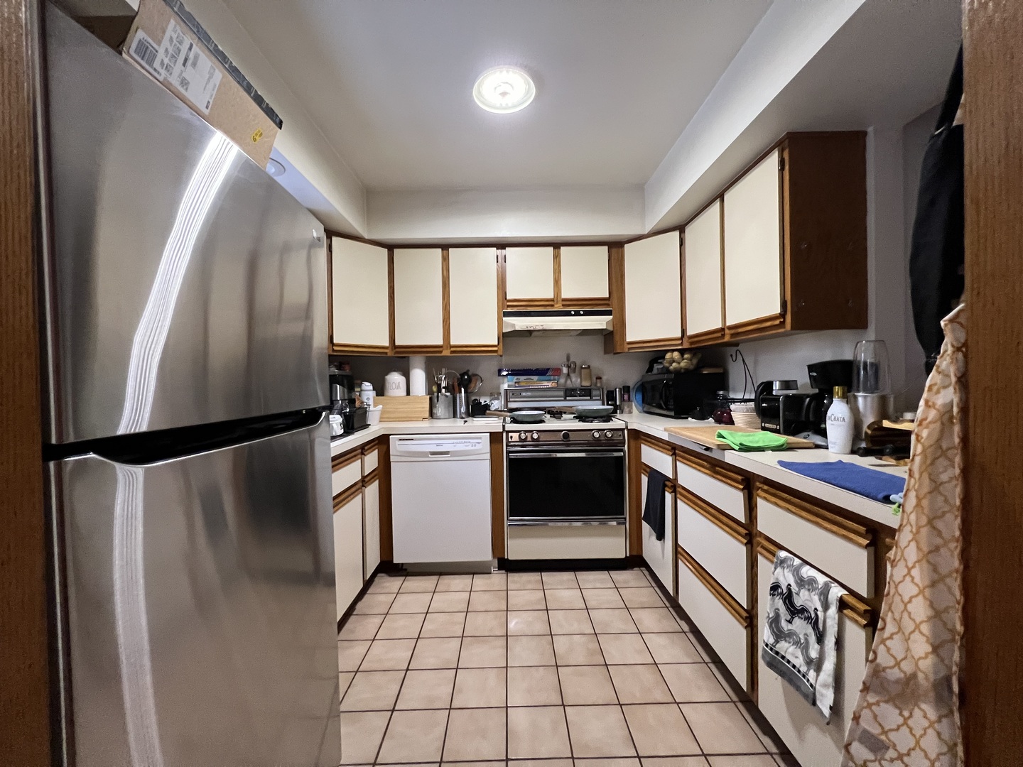 509 East Lake Avenue, Unit B Round Lake Beach, IL 60073 - Photo 7 of 18 a kitchen with a refrigerator a sink dishwasher a stove top oven a refrigerator and cabinets