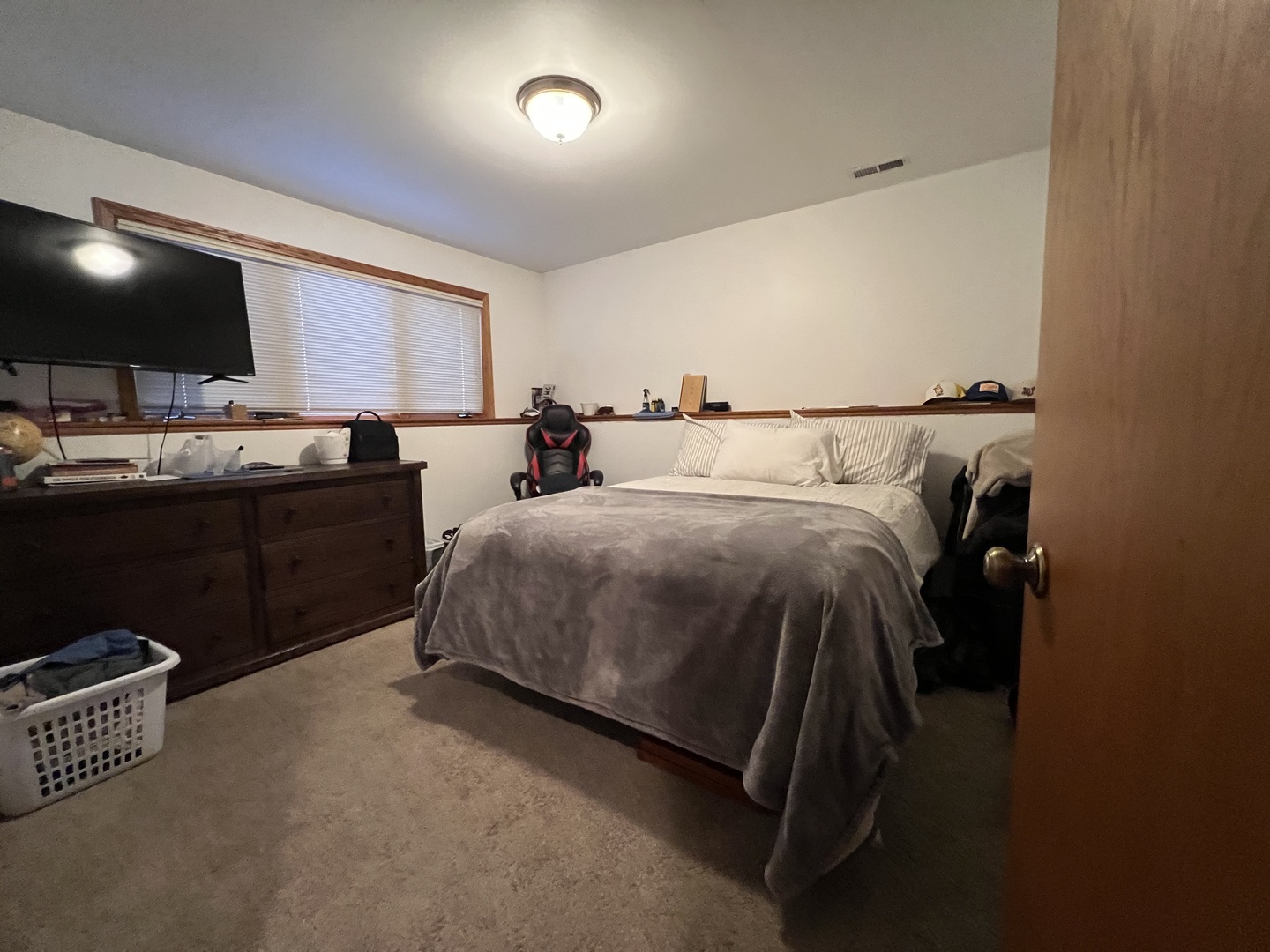 509 East Lake Avenue, Unit B Round Lake Beach, IL 60073 - Photo 10 of 18 a bed room with a bed and a flat screen tv