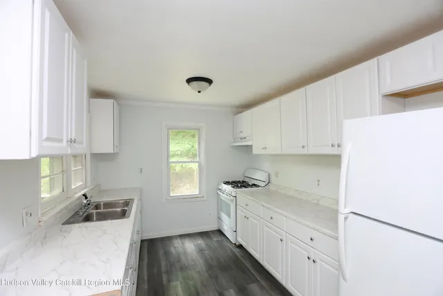 a kitchen with granite countertop a sink and wooden cabinets