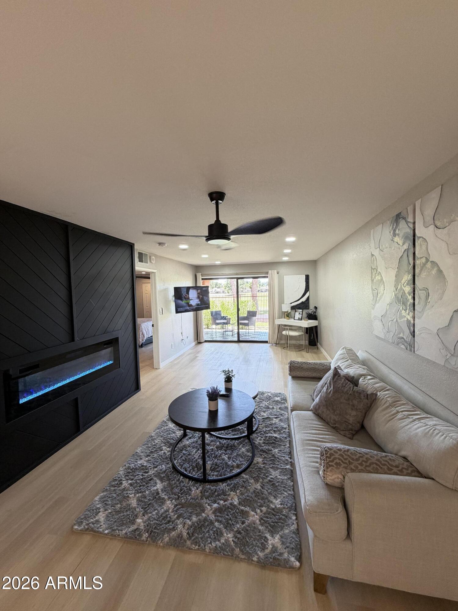 4303 East Cactus Road, Unit 128 Phoenix, AZ 85032 - Photo 35 of 39 a living room with furniture and a flat screen tv