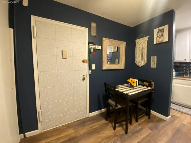 a view of a workspace with furniture and wooden floor