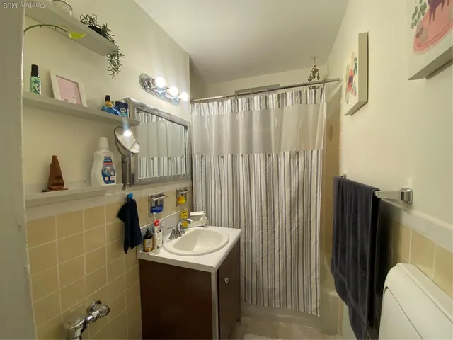 a bathroom with a sink a mirror and a shower