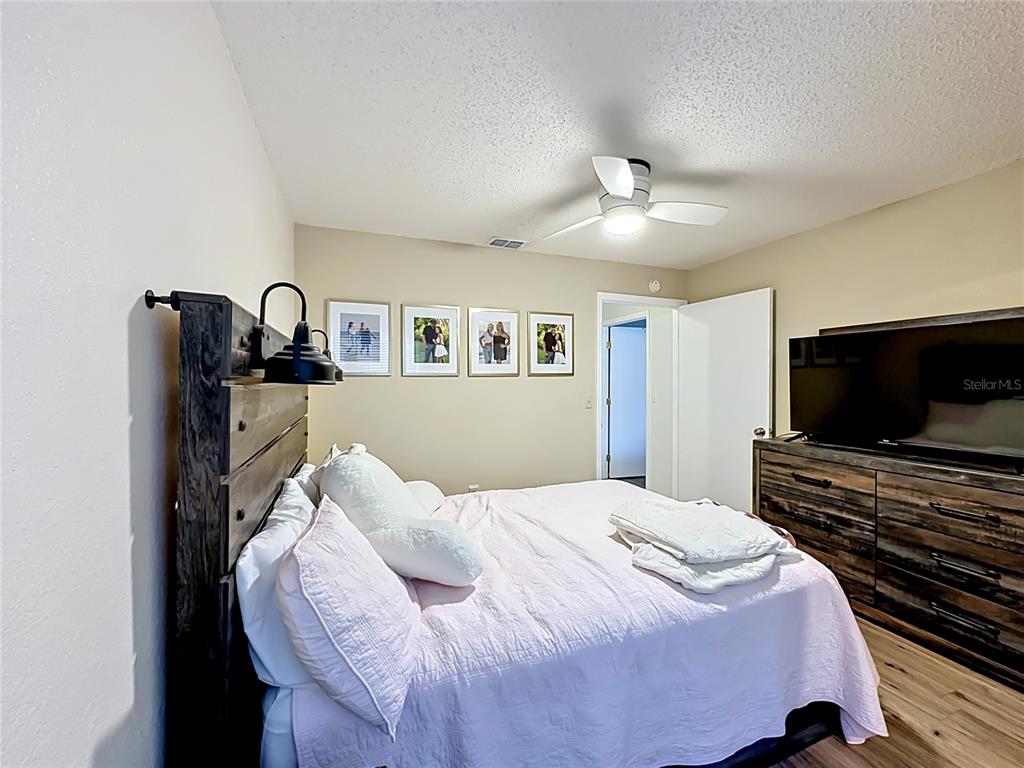 3705 Southwest 27th Street, Unit 922 Gainesville, FL 32608 - Photo 22 of 34 a bedroom with a bed and a flat screen tv