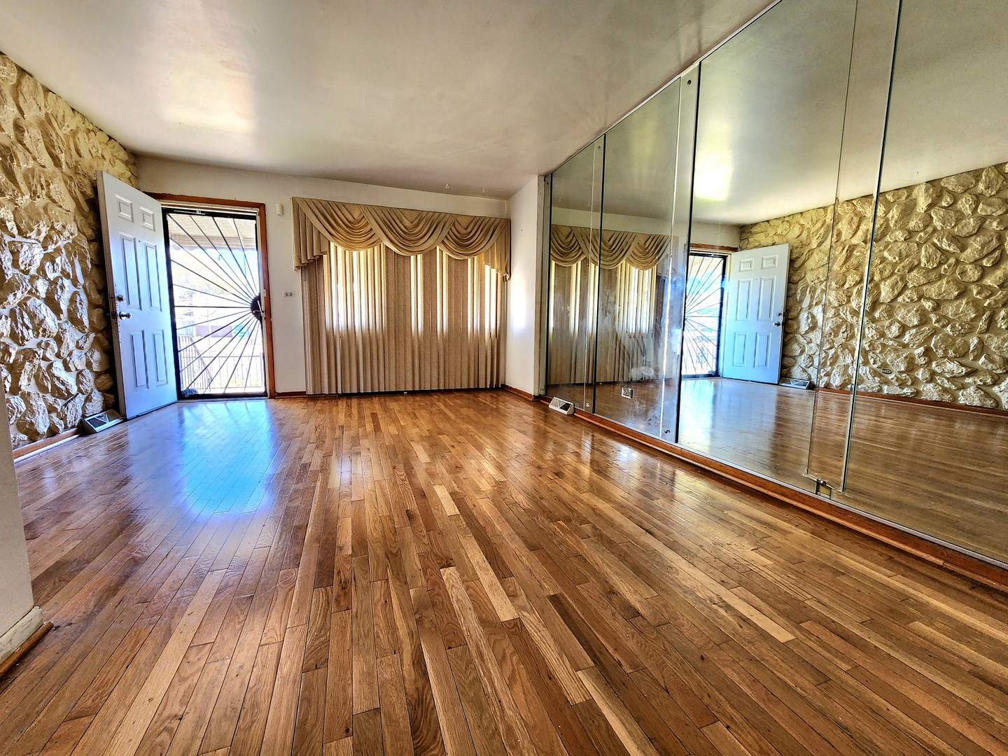9252 South Halsted Street, Unit A Chicago, IL 60620 - Photo 3 of 11 a view of wooden floor and windows in a room