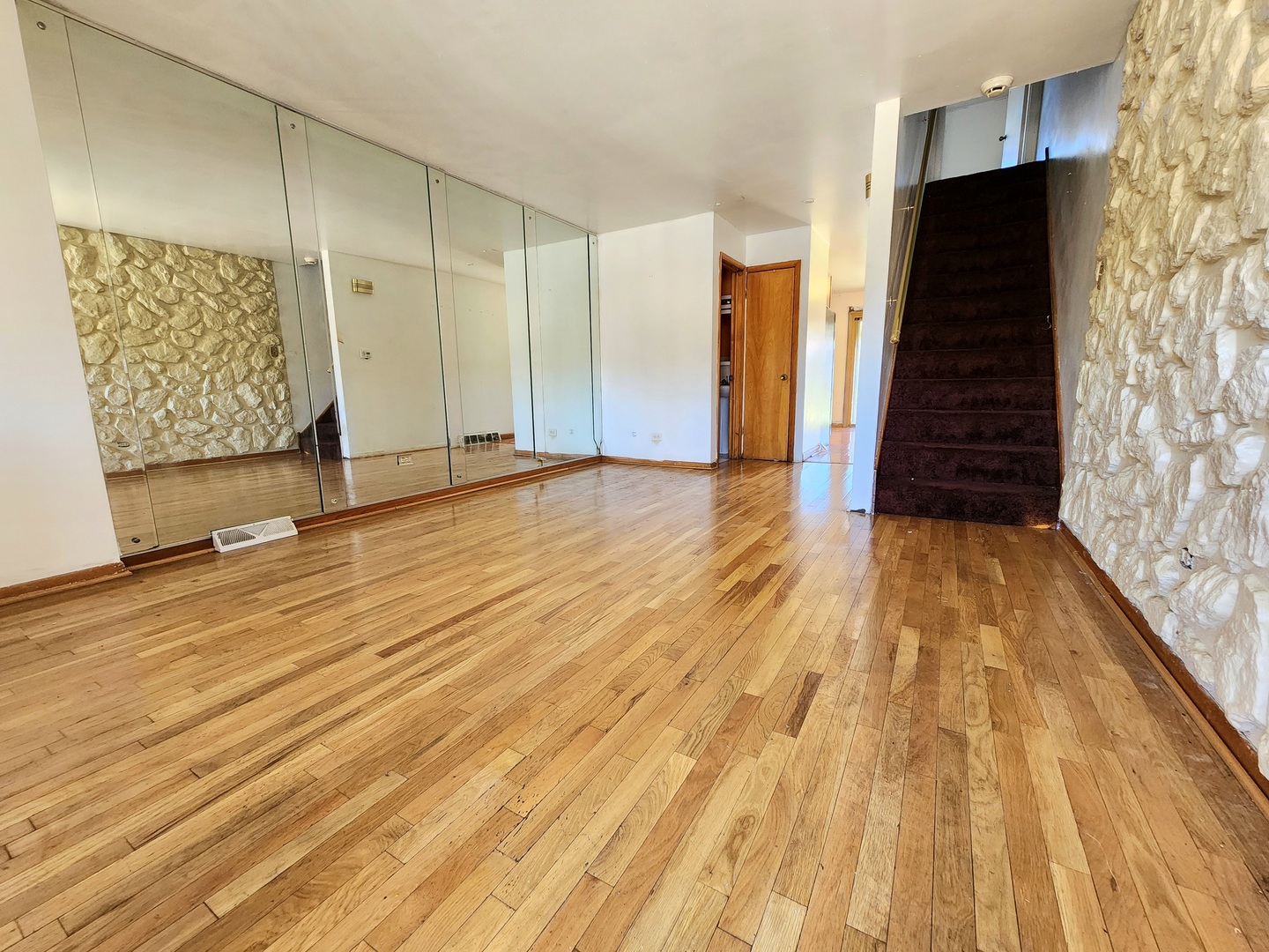 9252 South Halsted Street, Unit A Chicago, IL 60620 - Photo 4 of 11 a view of an empty room with wooden floor