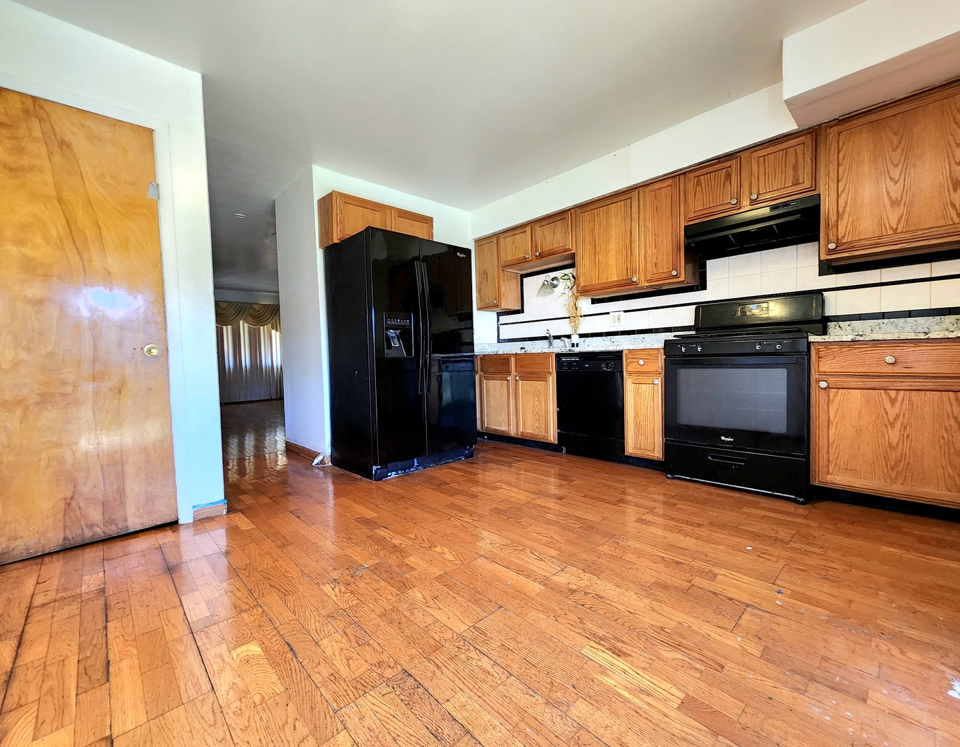9252 South Halsted Street, Unit A Chicago, IL 60620 - Photo 6 of 11 a kitchen with stainless steel appliances granite countertop a refrigerator and a stove top oven