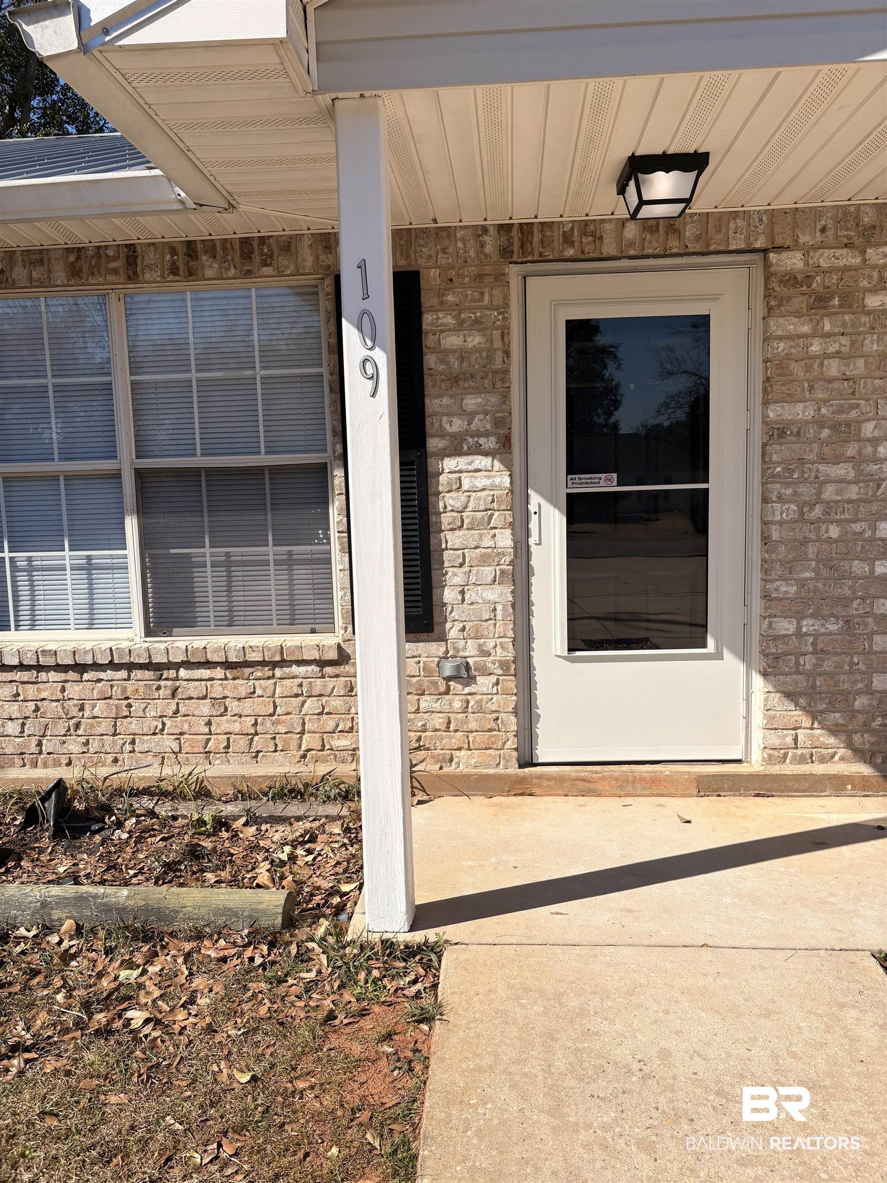 109-111 North Beech Street, Unit A & B Foley, AL 36535 - Photo 2 of 16 View of exterior entry featuring brick siding and covered porch