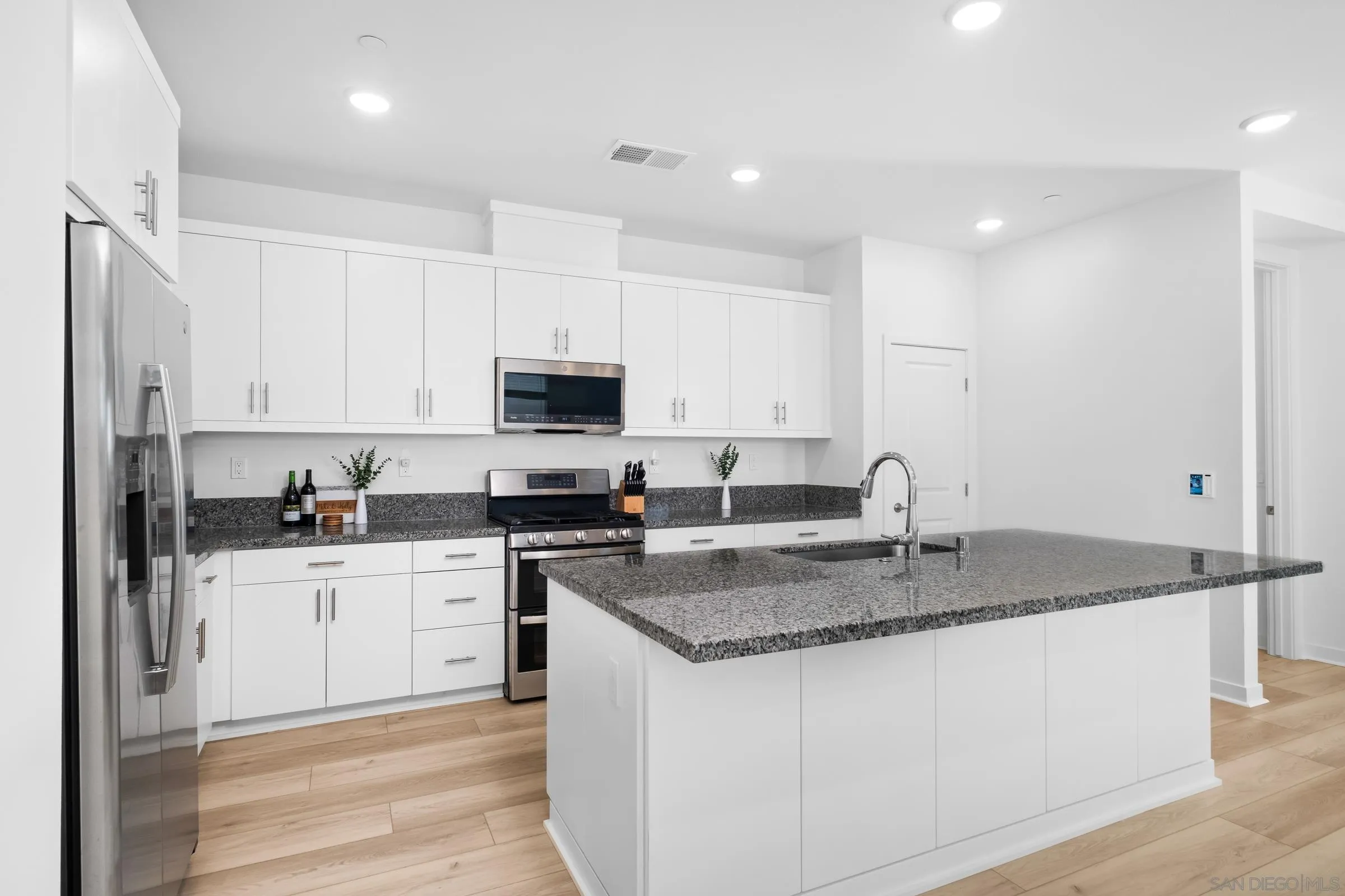 35164 Orchard Trail Fallbrook, CA 92028 - Photo 15 of 52 a kitchen with stainless steel appliances granite countertop a sink a stove and cabinets