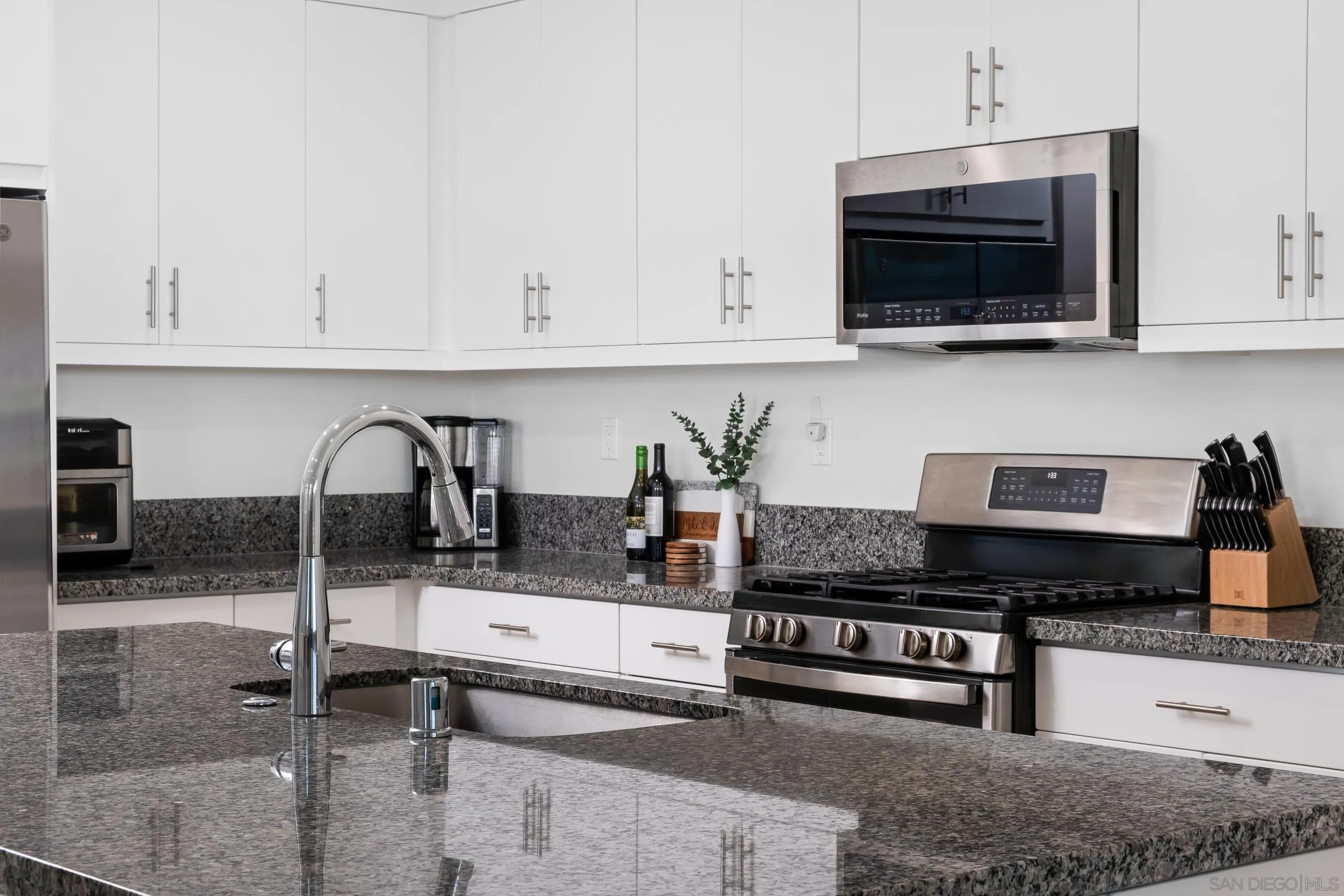 35164 Orchard Trail Fallbrook, CA 92028 - Photo 16 of 52 a kitchen with granite countertop a sink and a stove top oven
