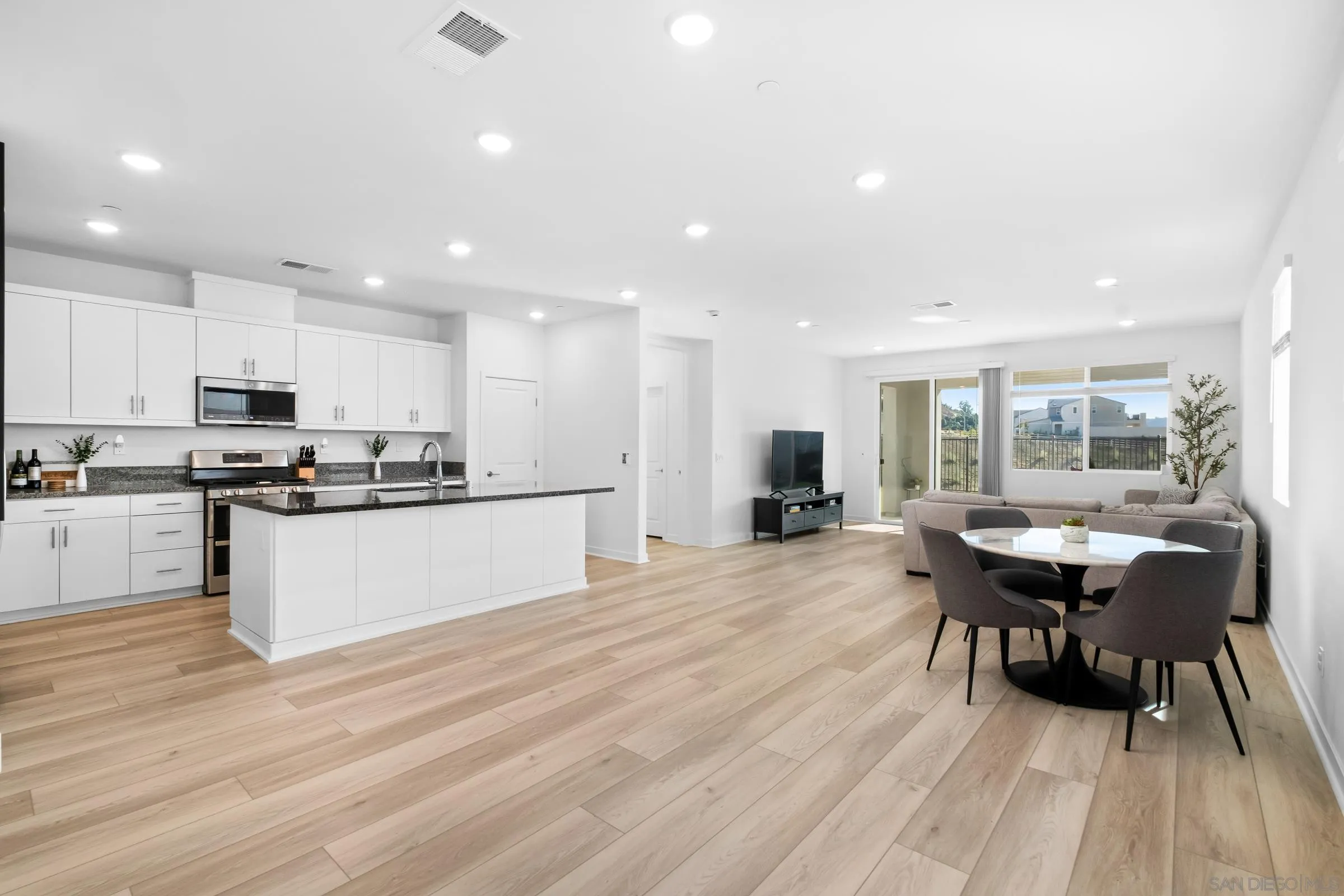 35164 Orchard Trail Fallbrook, CA 92028 - Photo 17 of 52 a large kitchen with kitchen island a white cabinets and wooden floor