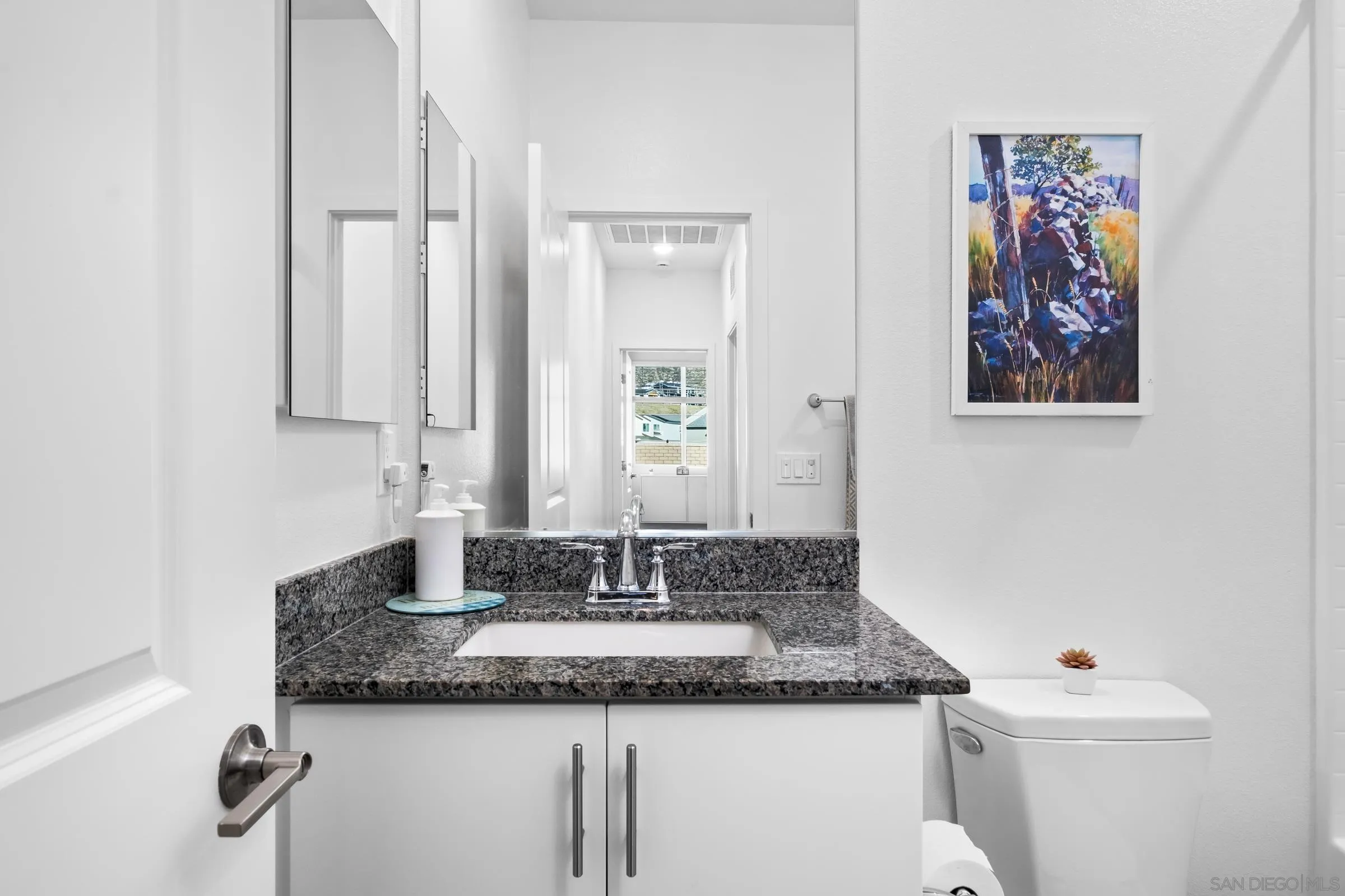 35164 Orchard Trail Fallbrook, CA 92028 - Photo 7 of 52 a bathroom with a granite countertop sink and a mirror