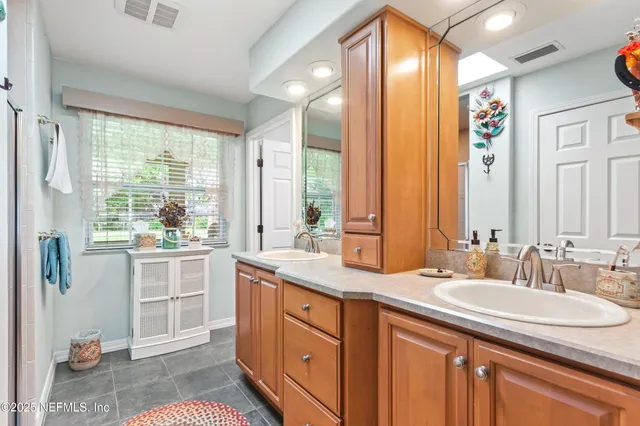 a bathroom with a granite countertop sink mirror and shower