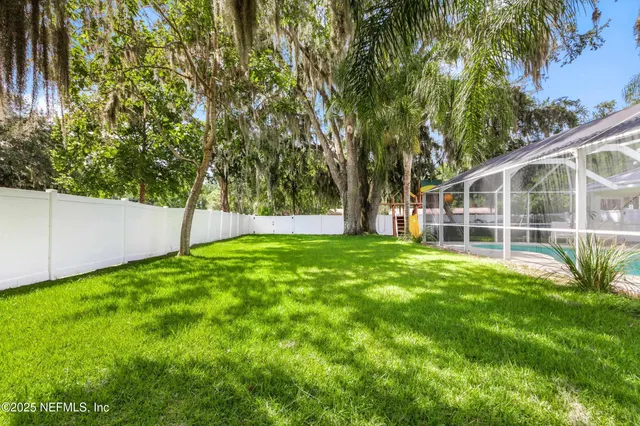 a view of a house with backyard and sitting area