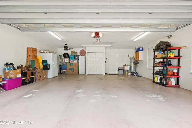 a view of a house with a yard and potted plants
