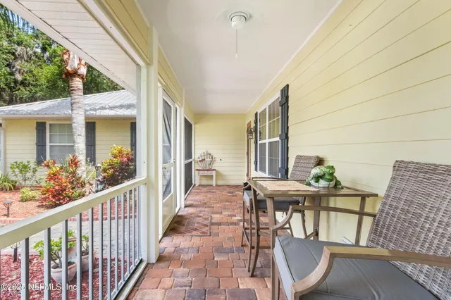 a view of a house with a big yard and large trees