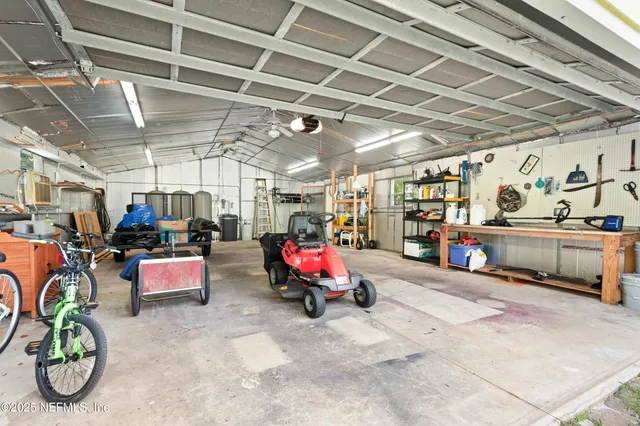 an aerial view of a house with swimming pool and garden