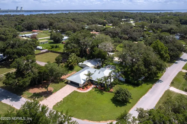 an aerial view of a house with a yard