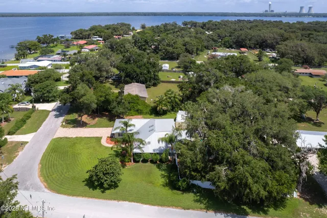 an aerial view of a house with a yard