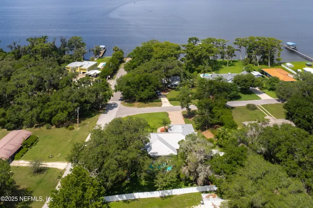an aerial view of a house with a yard