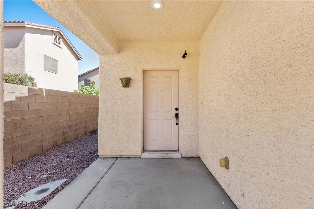 8934 Deep Ridge Court Las Vegas, NV 89178 - Photo 4 of 47 A welcoming covered entryway with clean concrete and a private block wall.