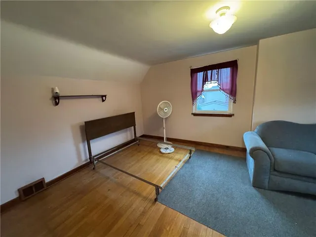 a living room with furniture pool table and window