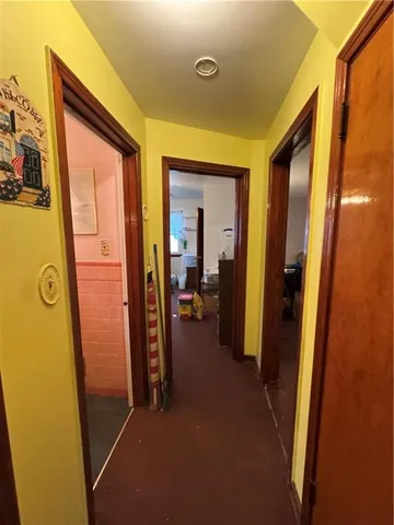 a view of a hallway with wooden shelves