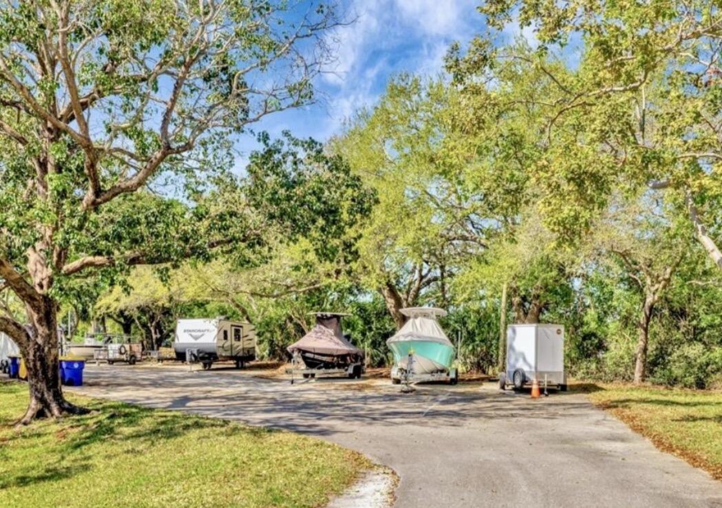 6537 Southeast Federal Highway, Unit 202 Stuart, FL 34997 - Photo 14 of 14 a view of a house with large trees