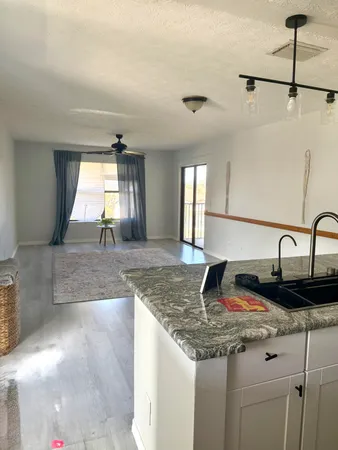 a bathroom with a granite countertop sink a mirror and vanity