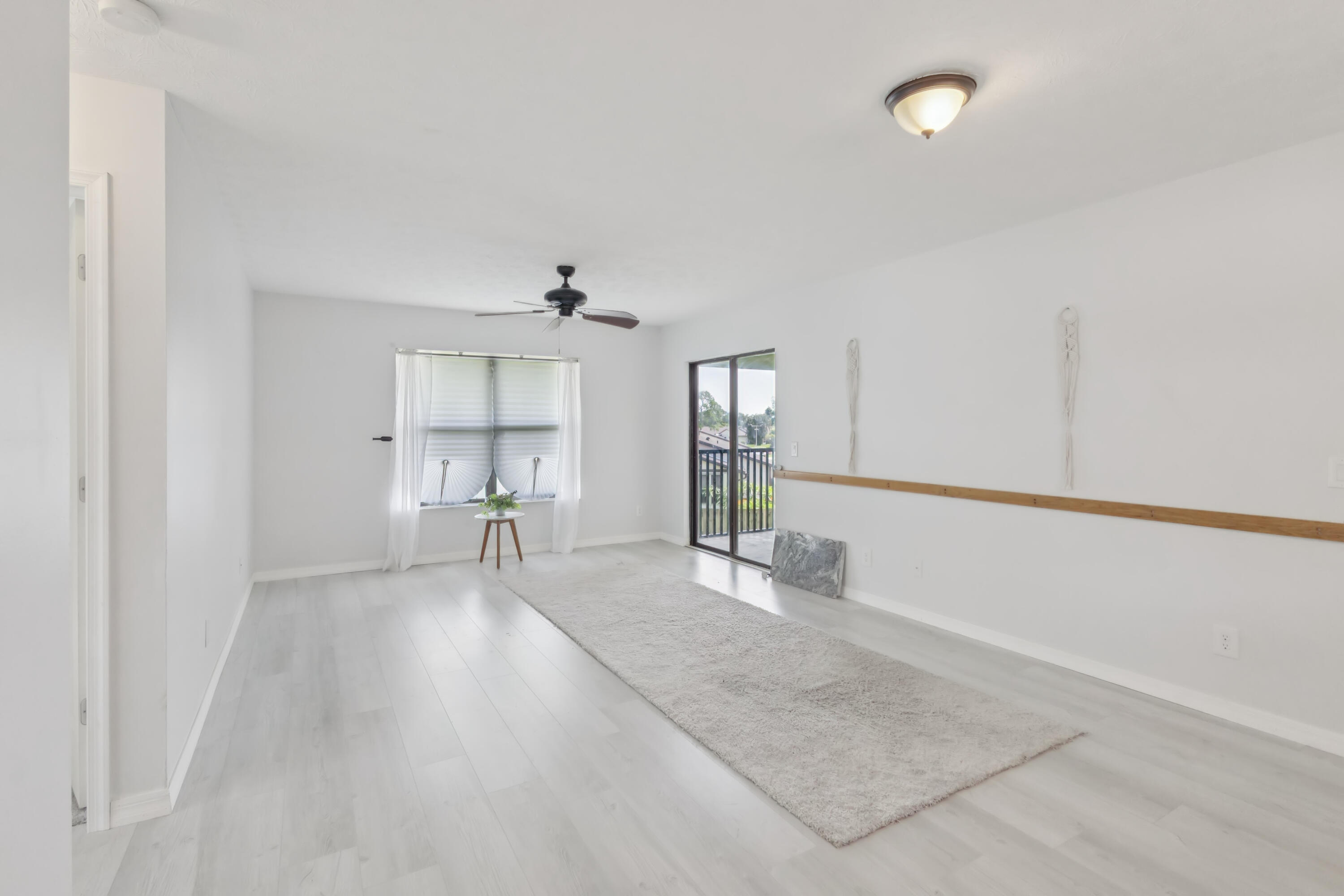 6537 Southeast Federal Highway, Unit 202 Stuart, FL 34997 - Photo 5 of 14 a view of empty room with wooden floor and fan